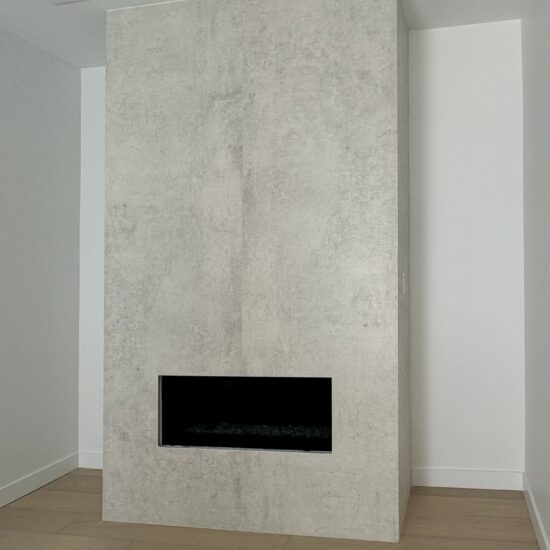 Modern stone fireplace installation in New Westminster and Metro Vancouver including Vancouver, Burnaby, Coquitlam, Surrey, Delta, Maple Ridge, Port Coquitlam, North Vancouver, West Vancouver and Downtown Vancouver. Dekton Lunar fireplace with seamless mitered edges.