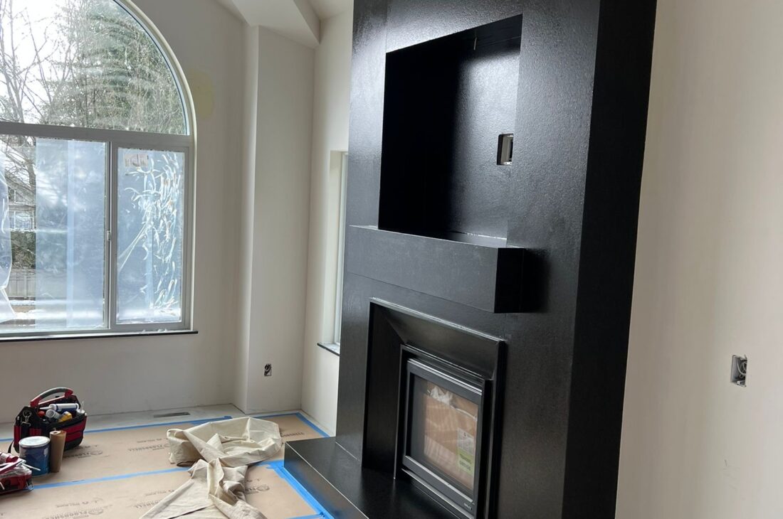 Custom granite fireplace supply, fabrication, and installation in Coquitlam and Metro Vancouver including Vancouver, Burnaby, Surrey, Delta, Maple Ridge, Port Coquitlam, North Vancouver and West Vancouver. Modern full-height stone fireplace walls with premium finishes.