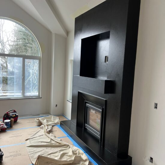 Custom granite fireplace supply, fabrication, and installation in Coquitlam and Metro Vancouver including Vancouver, Burnaby, Surrey, Delta, Maple Ridge, Port Coquitlam, North Vancouver and West Vancouver. Modern full-height stone fireplace walls with premium finishes.