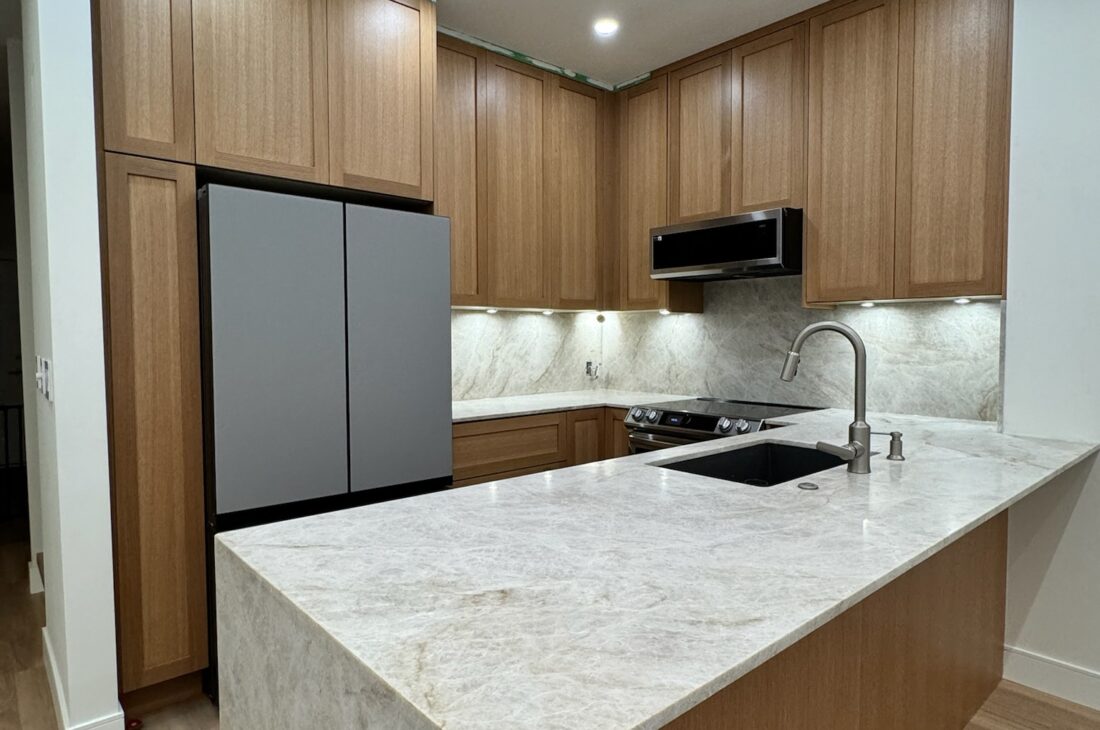 2cm honed Taj Mahal quartzite countertops and full backsplash installation in Metro Vancouver including Vancouver, Burnaby, Coquitlam, Surrey, Delta, Maple Ridge, Port Coquitlam, North Vancouver, West Vancouver and Downtown Vancouver. Luxury natural stone kitchen with waterfall island and seamless design.