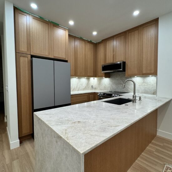 2cm honed Taj Mahal quartzite countertops and full backsplash installation in Metro Vancouver including Vancouver, Burnaby, Coquitlam, Surrey, Delta, Maple Ridge, Port Coquitlam, North Vancouver, West Vancouver and Downtown Vancouver. Luxury natural stone kitchen with waterfall island and seamless design.