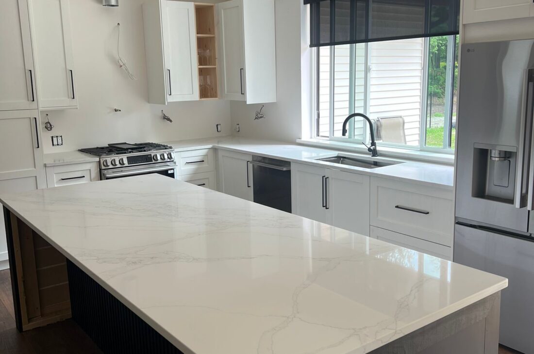 Custom quartz countertops in Maple Ridge featuring Hari Stone Irah 514 Borghini in 3cm thickness. Full kitchen countertops, island, window sill, and custom quartz sink cover professionally fabricated and installed by MeVa Granite.